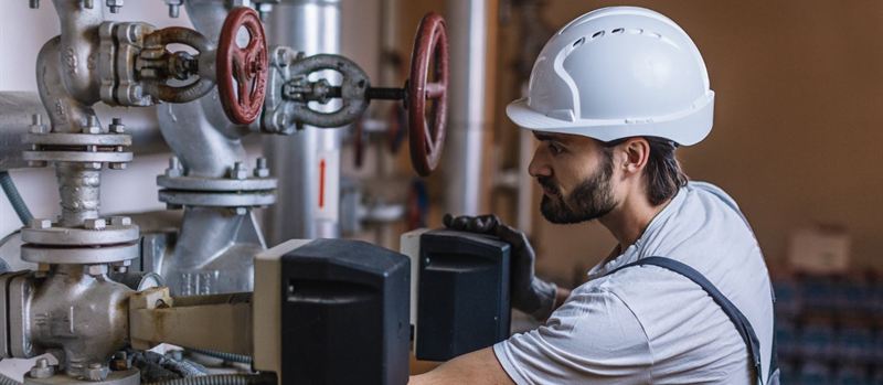 Commercial gas engineer checking plant room valves and gauges in Glasgow | Gas Main Installation Commercial gas engineer checking plant room valves and gauges in Glasgow