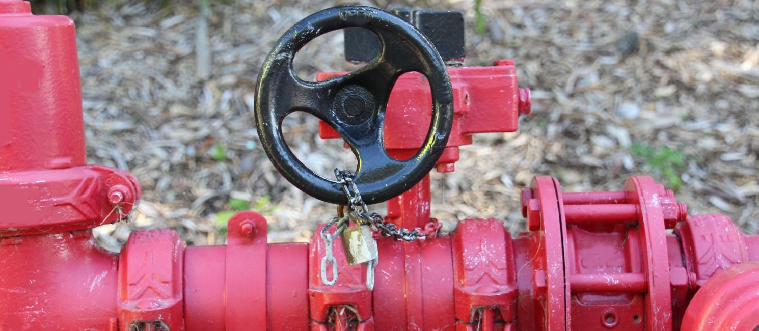 Red industrial gas pipeline with a locked valve at a site in Wolverhampton