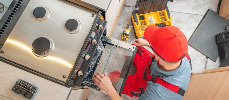 Engineer connecting a gas oven during a kitchen installation in Herne Bay | Gas Main Installation Engineer connecting a gas oven during a kitchen installation in Herne Bay