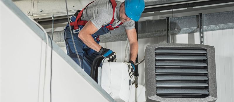Engineer servicing a high-level warehouse gas heater in Kirkby | Gas Main Installation Engineer servicing a high-level warehouse gas heater in Kirkby