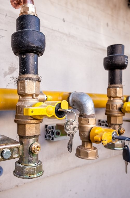 Commercial gas pipework with brass fittings and yellow lockable isolation valves
